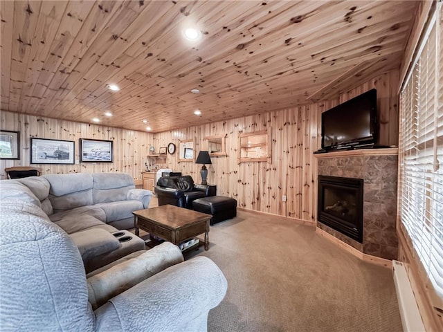 7310 Moose Lake Rd NE, Blackduck, MN 56630 - carpeted living area with baseboard heating, wooden ceiling, wood walls, a tile fireplace, and recessed lighting