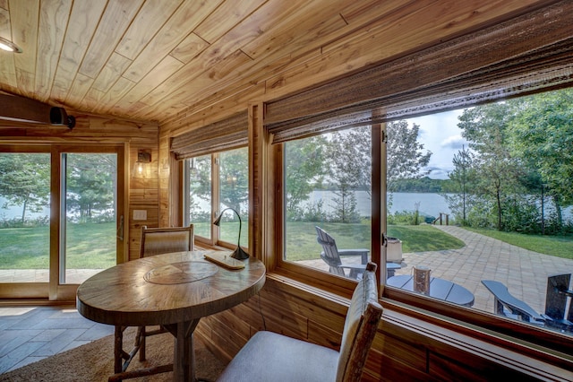 16267 Conners Ln, Sand Lake Twp, WI 54876 - sunroom featuring a water view, wood walls, wood ceiling, and stone tile flooring
