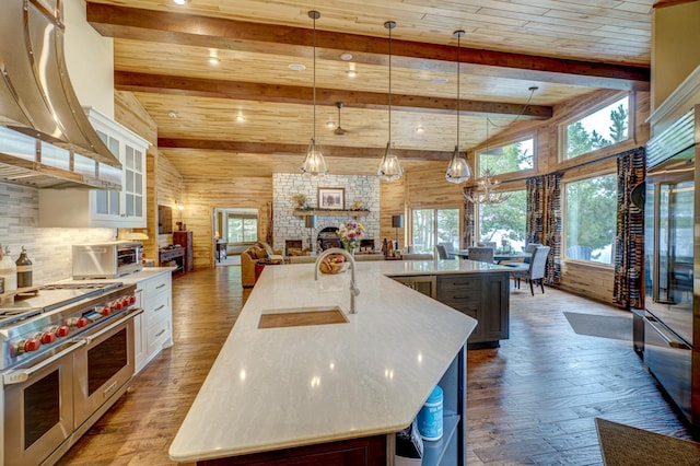 16267 Conners Ln, Sand Lake Twp, WI 54876 - kitchen with double oven range, hardwood / wood-style floors, a spacious island, a fireplace, and open floor plan