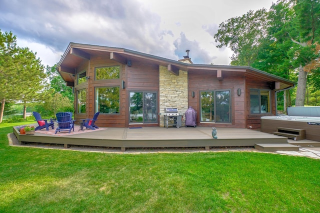 16267 Conners Ln, Sand Lake Twp, WI 54876 - back of property with a hot tub, a wooden deck, and a yard
