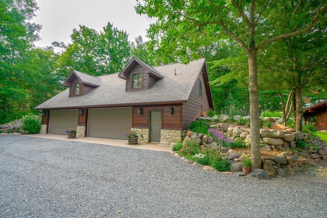 16267 Conners Ln, Sand Lake Twp, WI 54876 - view of front of home with stone siding, a shingled roof, and gravel driveway