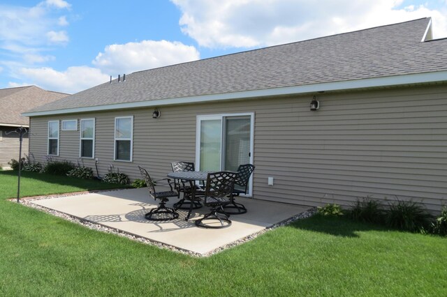 307 14th St N, Cold Spring, MN 56320 - rear view of property with a patio, a yard, and a shingled roof