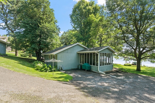 20592 Lehmicke Ln, Trade Lake, WI 54853 - view of home's exterior with a sunroom and a yard