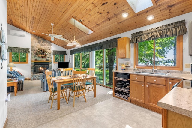 20592 Lehmicke Ln, Trade Lake, WI 54853 - kitchen featuring a skylight, a fireplace, healthy amount of natural light, a wall mounted AC, and wooden ceiling