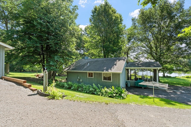 20592 Lehmicke Ln, Trade Lake, WI 54853 - view of side of home featuring a chimney, a shingled roof, and a yard