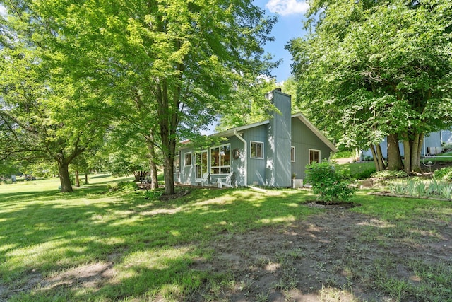 20592 Lehmicke Ln, Trade Lake, WI 54853 - view of side of home featuring a chimney and a lawn