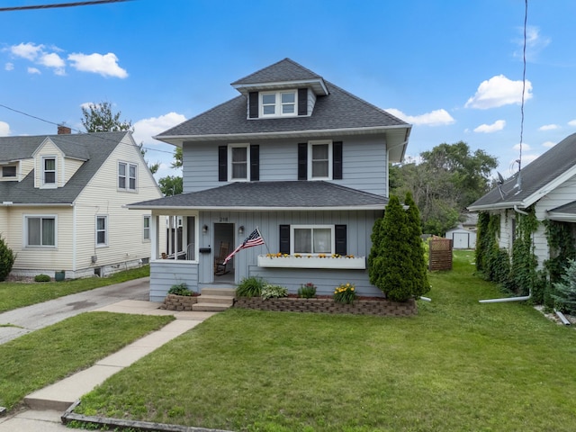 218 11th Ave NE, Rochester, MN 55906 - view of front of property with a shingled roof, a storage unit, a front yard, a porch, and board and batten siding