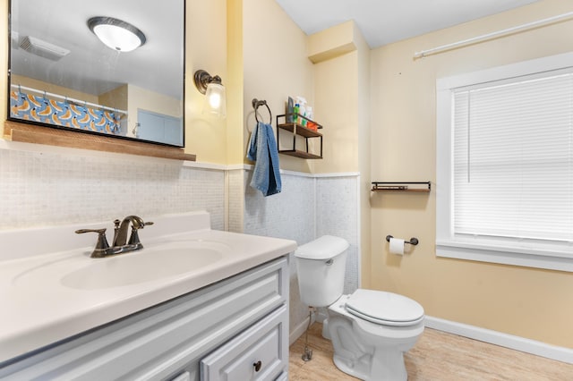 218 11th Ave NE, Rochester, MN 55906 - bathroom with vanity, tile walls, curtained shower, a wainscoted wall, and wood finished floors