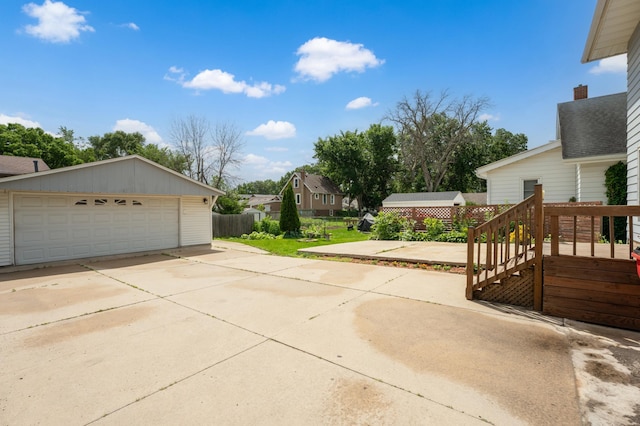 218 11th Ave NE, Rochester, MN 55906 - view of side of property featuring a garage, a residential view, an outbuilding, and a wooden deck