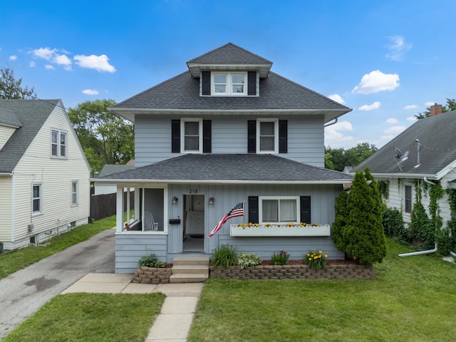 218 11th Ave NE, Rochester, MN 55906 - american foursquare style home with a shingled roof, driveway, a front yard, and board and batten siding