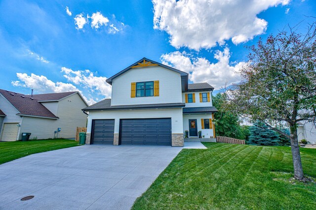 21 Windsor Wood Path, Hudson, WI 54016 - view of front facade with an attached garage, stone siding, a front lawn, and driveway
