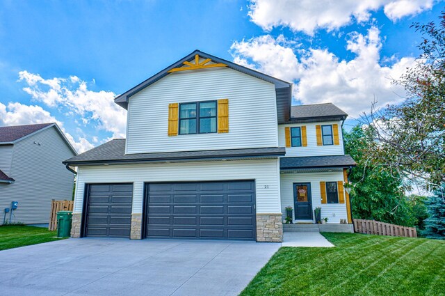 21 Windsor Wood Path, Hudson, WI 54016 - view of front of house with driveway, a front lawn, an attached garage, stone siding, and a shingled roof