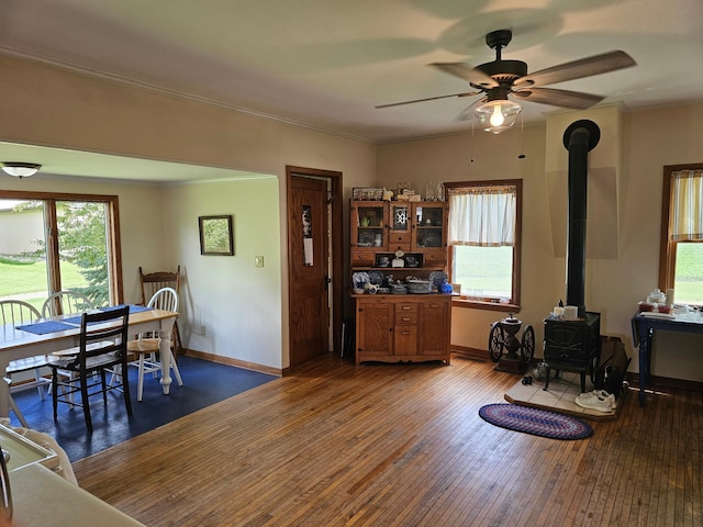 86389 245th St, Albert Lea, MN 56007 - living room with a wood stove, a ceiling fan, hardwood / wood-style flooring, and crown molding