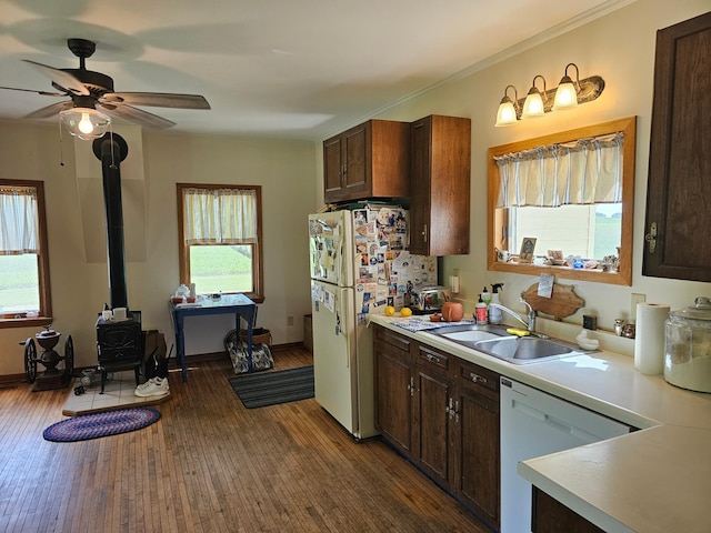 86389 245th St, Albert Lea, MN 56007 - kitchen featuring white appliances, light countertops, a wood stove, and plenty of natural light