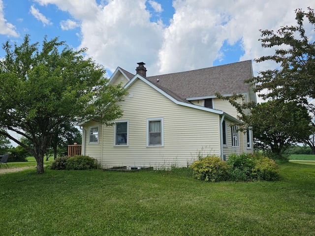 86389 245th St, Albert Lea, MN 56007 - view of property exterior with a chimney, a lawn, and a shingled roof