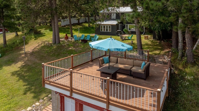 36722 Birch Dr, Jenkins Twp, MN 56474 - wooden deck featuring an outdoor living space, a yard, a garage, and an outdoor structure