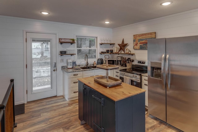 36722 Birch Dr, Jenkins Twp, MN 56474 - kitchen with stainless steel appliances, butcher block countertops, open shelves, white cabinetry, and light wood finished floors