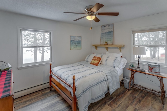 36722 Birch Dr, Jenkins Twp, MN 56474 - bedroom with a baseboard radiator, wood finished floors, and ceiling fan