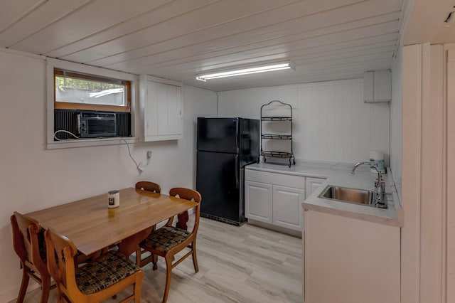 36722 Birch Dr, Jenkins Twp, MN 56474 - kitchen with freestanding refrigerator, white cabinets, cooling unit, light countertops, and light wood-type flooring