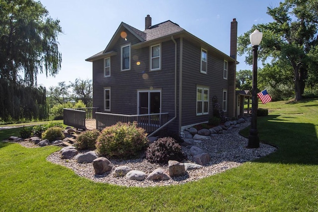 37437 State Highway 7, Big Stone Twp, MN 56278 - view of side of property with a wooden deck, a yard, and a chimney