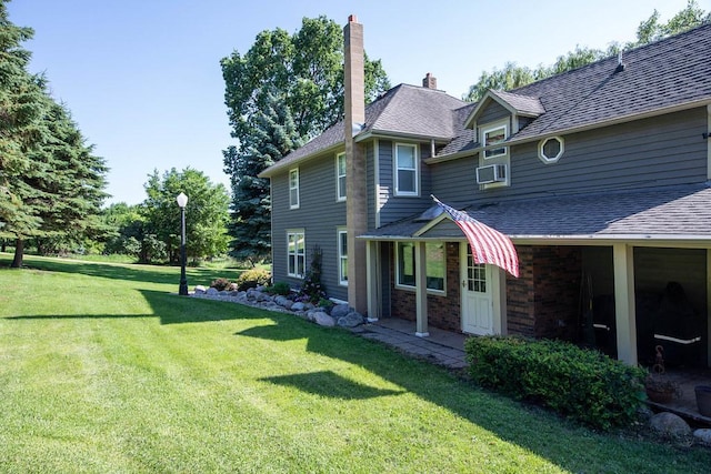 37437 State Highway 7, Big Stone Twp, MN 56278 - view of property exterior featuring a lawn, a chimney, cooling unit, roof with shingles, and brick siding