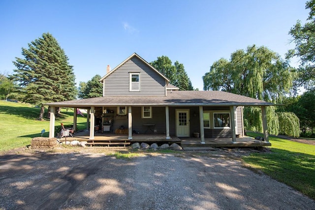 37437 State Highway 7, Big Stone Twp, MN 56278 - farmhouse with covered porch, a front yard, and a chimney