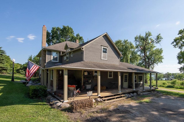 37437 State Highway 7, Big Stone Twp, MN 56278 - view of front facade featuring a front lawn, covered porch, and a chimney