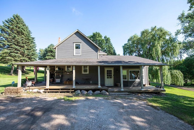 37437 State Highway 7, Big Stone Twp, MN 56278 - farmhouse inspired home featuring covered porch, a front lawn, a chimney, and a shingled roof