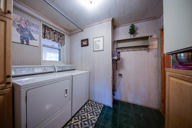 37437 State Highway 7, Big Stone Twp, MN 56278 - washroom with washing machine and dryer, crown molding, cabinet space, dark tile patterned floors, and wood walls