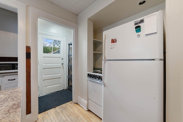 211 Saint Marie St, Duluth, MN 55803 - kitchen featuring white appliances, light wood finished floors, and light countertops