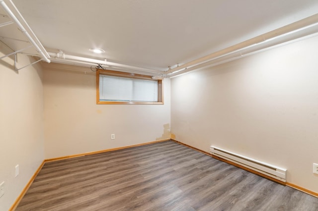 211 Saint Marie St, Duluth, MN 55803 - finished basement with a baseboard heating unit, wood finished floors, and recessed lighting
