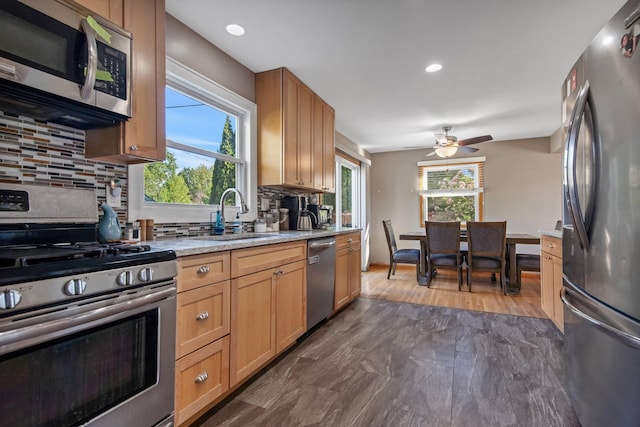3237 Jerry Ct, White Bear Lake, MN 55110 - kitchen with appliances with stainless steel finishes, backsplash, ceiling fan, recessed lighting, and light stone counters