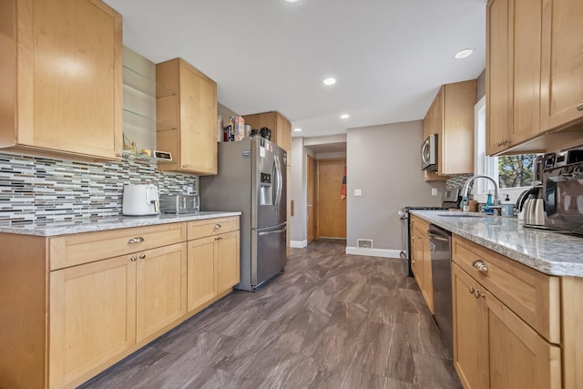3237 Jerry Ct, White Bear Lake, MN 55110 - kitchen featuring stainless steel appliances, decorative backsplash, light stone counters, light brown cabinets, and recessed lighting