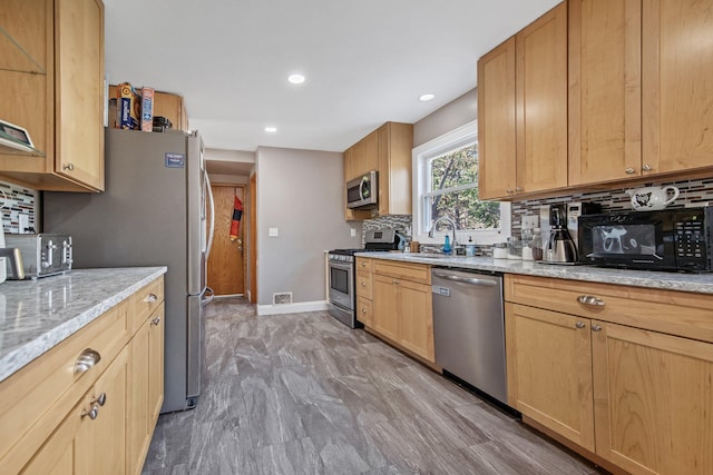 3237 Jerry Ct, White Bear Lake, MN 55110 - kitchen with stainless steel appliances, backsplash, light stone countertops, recessed lighting, and light brown cabinets