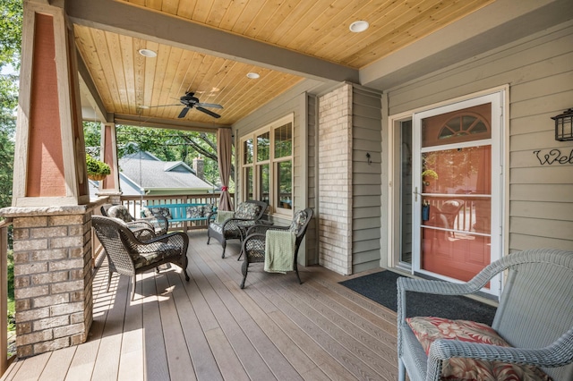 12145 Jonquil St NW, Coon Rapids, MN 55433 - wooden porch with a ceiling fan and an outdoor living space