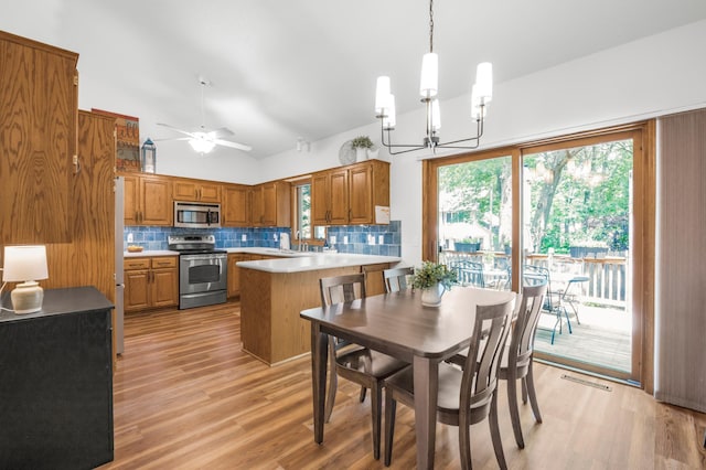 12145 Jonquil St NW, Coon Rapids, MN 55433 - dining area with a chandelier, light wood-style flooring, healthy amount of natural light, a ceiling fan, and vaulted ceiling