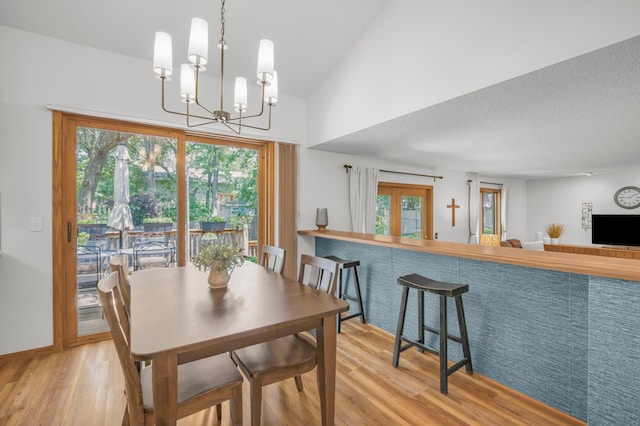 12145 Jonquil St NW, Coon Rapids, MN 55433 - dining space featuring wood finished floors and a chandelier
