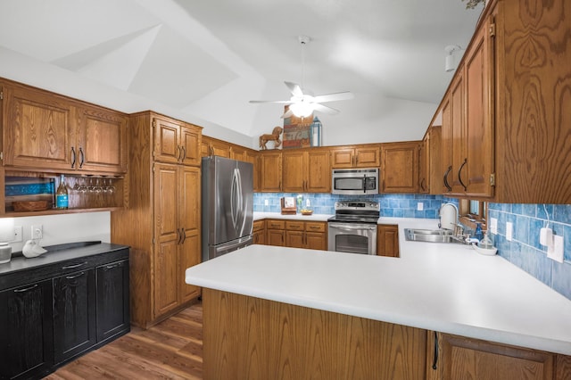 12145 Jonquil St NW, Coon Rapids, MN 55433 - kitchen featuring appliances with stainless steel finishes, light countertops, a ceiling fan, vaulted ceiling, and dark wood-type flooring