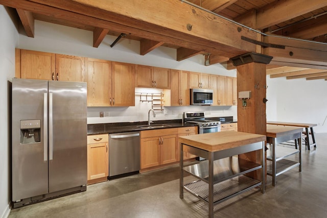 404 Washington Ave N Unit 304, Minneapolis, MN 55401 - kitchen featuring appliances with stainless steel finishes, finished concrete flooring, beamed ceiling, dark countertops, and light brown cabinets