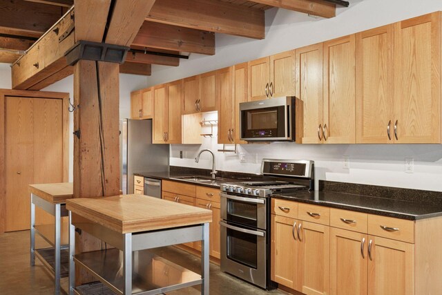 404 Washington Ave N Unit 304, Minneapolis, MN 55401 - kitchen with stainless steel appliances, light brown cabinets, beamed ceiling, and dark countertops