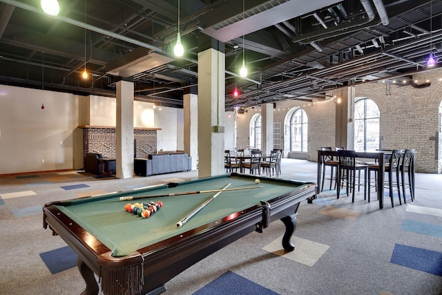 404 Washington Ave N Unit 304, Minneapolis, MN 55401 - game room with pool table, brick wall, a fireplace, and carpet flooring
