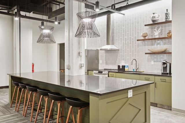 404 Washington Ave N Unit 304, Minneapolis, MN 55401 - kitchen with green cabinetry, tasteful backsplash, dark countertops, and freestanding refrigerator