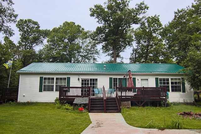 23829 Bulrush Dr, Lake Edward Twp, MN 56465 - view of front of property featuring a deck, a front yard, and a metal roof
