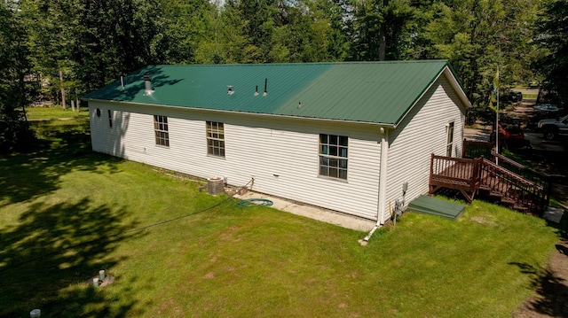 23829 Bulrush Dr, Lake Edward Twp, MN 56465 - rear view of house with a yard, a wooden deck, and a metal roof