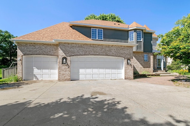 1110 Lecuyer Dr, Stillwater, MN 55082 - view of front of house featuring driveway, brick siding, a shingled roof, and a garage
