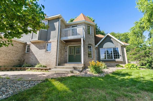 1110 Lecuyer Dr, Stillwater, MN 55082 - rear view of house with a balcony, french doors, a yard, brick siding, and entry steps