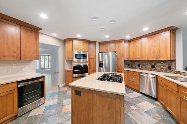1110 Lecuyer Dr, Stillwater, MN 55082 - kitchen with appliances with stainless steel finishes, beverage cooler, light stone finish floors, backsplash, and a center island