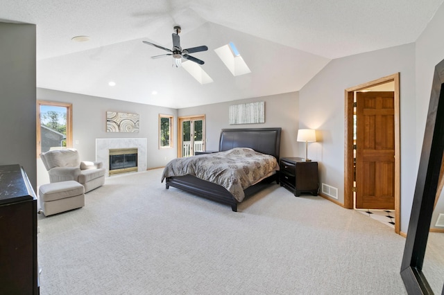 1110 Lecuyer Dr, Stillwater, MN 55082 - carpeted bedroom featuring a skylight, lofted ceiling, a premium fireplace, ceiling fan, and recessed lighting