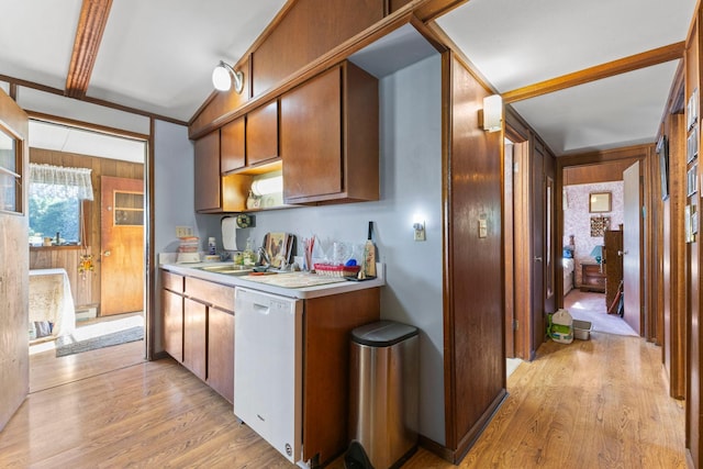 674 Greer Ave NW, Maple Lake, MN 55358 - kitchen with white dishwasher, light wood finished floors, light countertops, wooden walls, and brown cabinetry