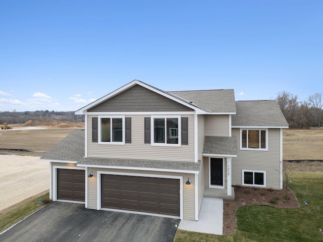 17006 Traprock St NW, Ramsey, MN 55303 - view of front of home featuring driveway, roof with shingles, an attached garage, and a front yard